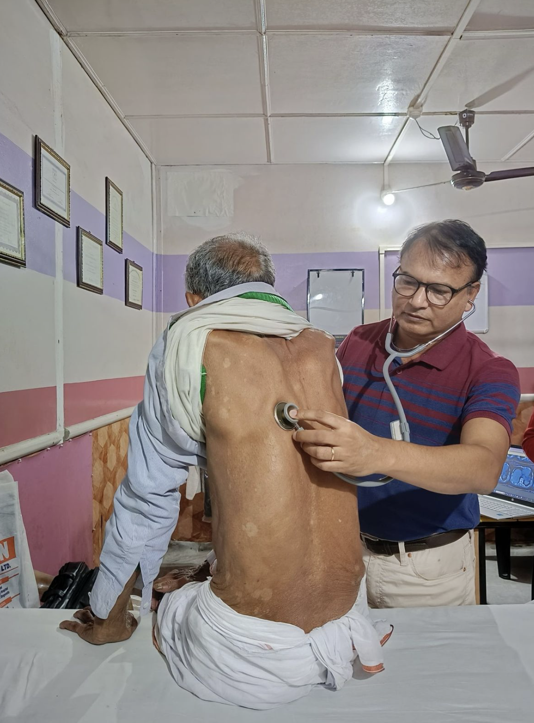 Dr. Bikul Das examining a patient at the KTC centre
